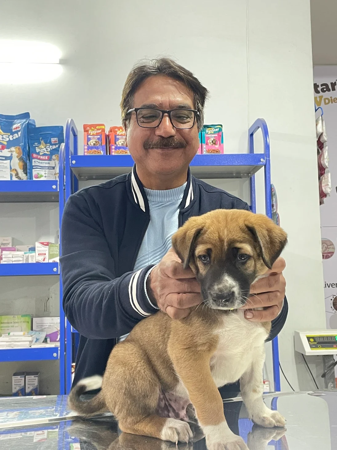 Team member with a puppy at the pet shop counter